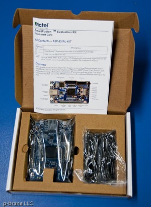 Photo of the SmartFusion evaluation board, box, and instructions.